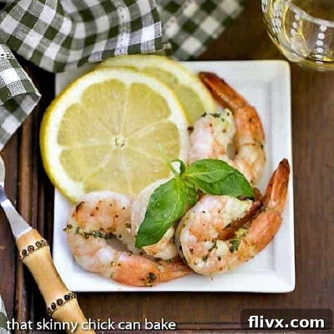 Platter of perfectly grilled shrimp scampi, glistening with garlic butter and herbs, ready to be served.