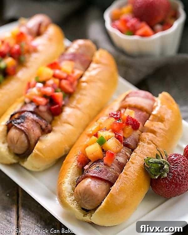An appetizing spread of Bacon Wrapped Hot Dogs with vibrant Fruit Salsa beautifully arranged on a rustic serving tray, perfect for a garden party.