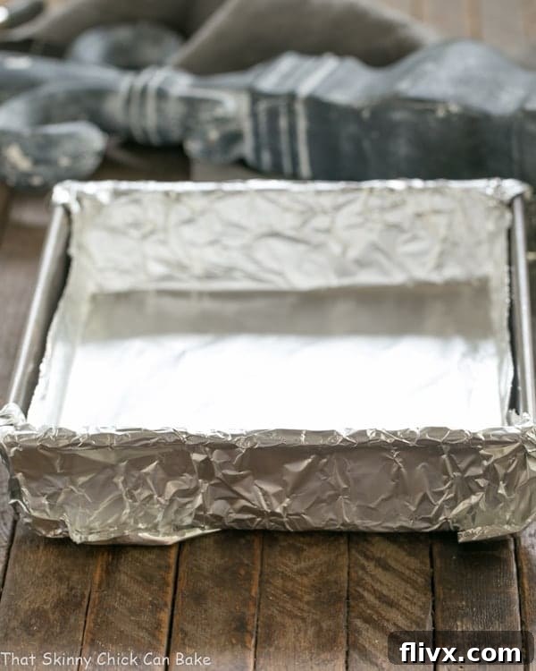Baking pan carefully lined with non-stick foil, ready for batter