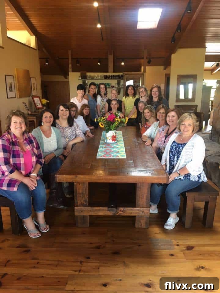 A group of people sitting at a table at the Pioneer Woman\'s studio.