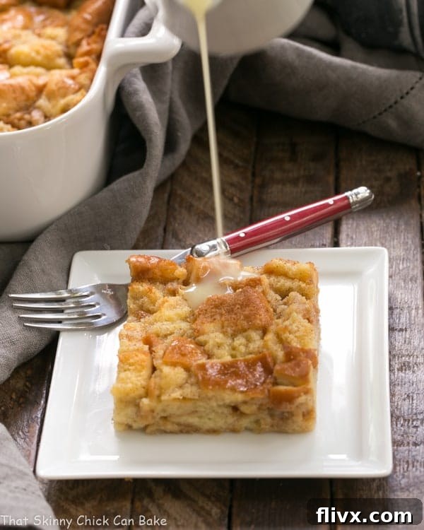 Whiskey sauce pouring over Cinnamon Bread Pudding.