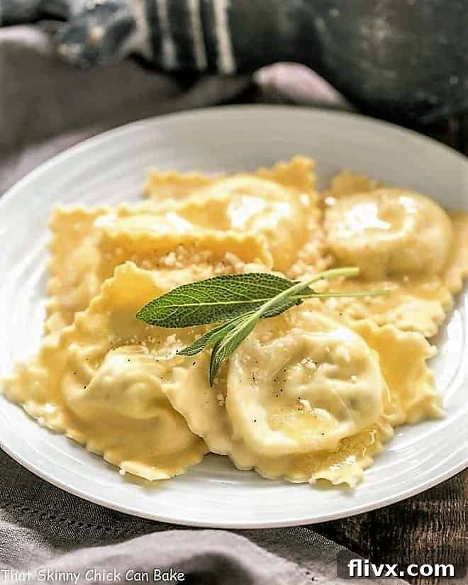 Freshly made ravioli resting on a pristine white plate, garnished with vibrant sage leaves. This Mozzarella, Basil, Parmigiano-Reggiano Ravioli is a testament to simple, delectable egg pasta.