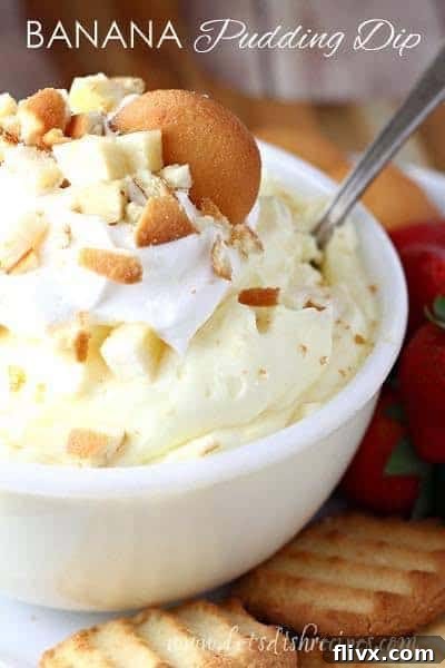 A white bowl of creamy banana pudding dip garnished with vanilla wafers, ready for dipping.