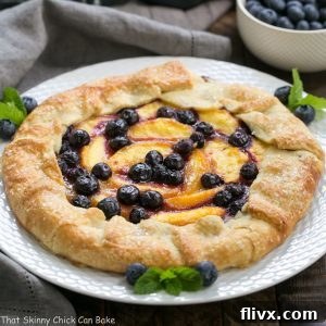 A stunning Peach Blueberry Galette, freshly baked with a golden crust and glistening fruit filling, ready to be served.