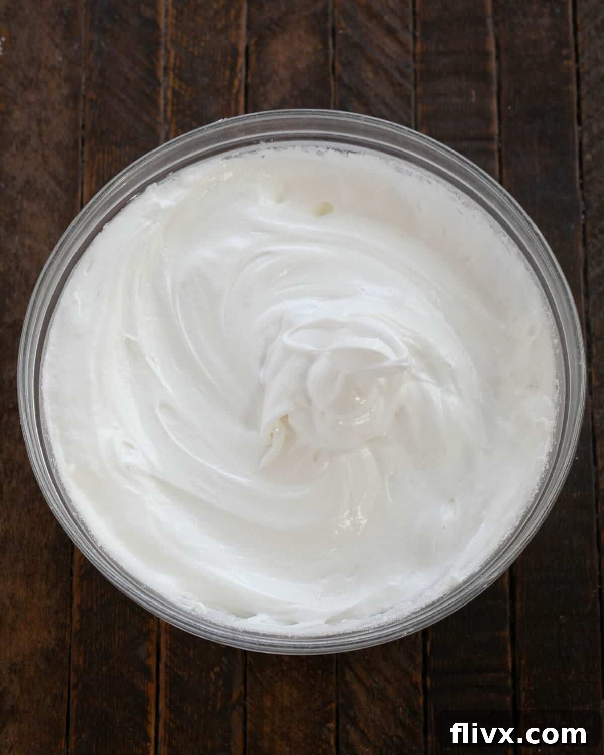 Egg whites beaten to stiff, glossy peaks with superfine sugar incorporated.