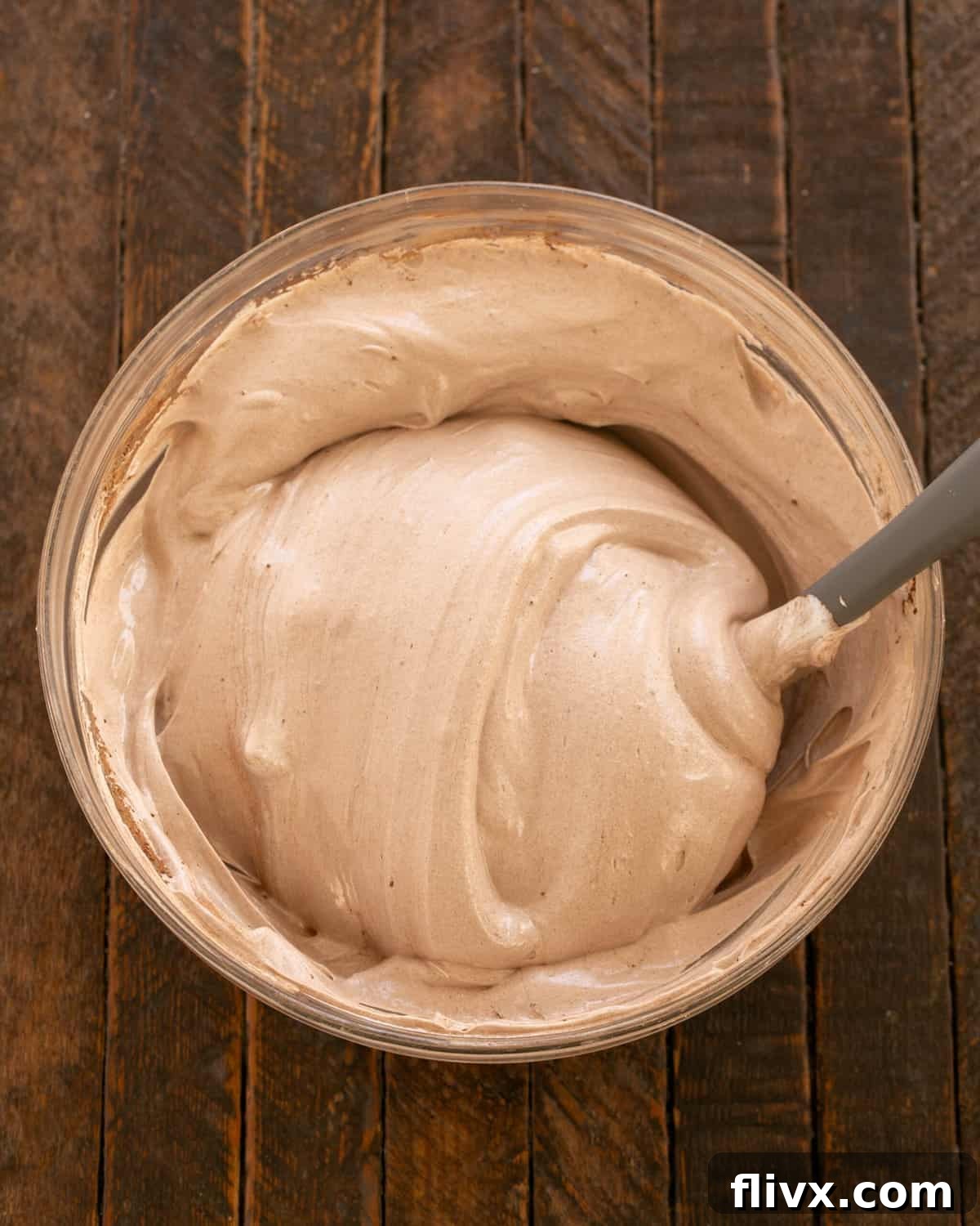 Meringue mixture combined with chocolate and cocoa, ready to be spread onto parchment.