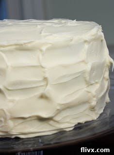 A close up of a red velvet cake frosting