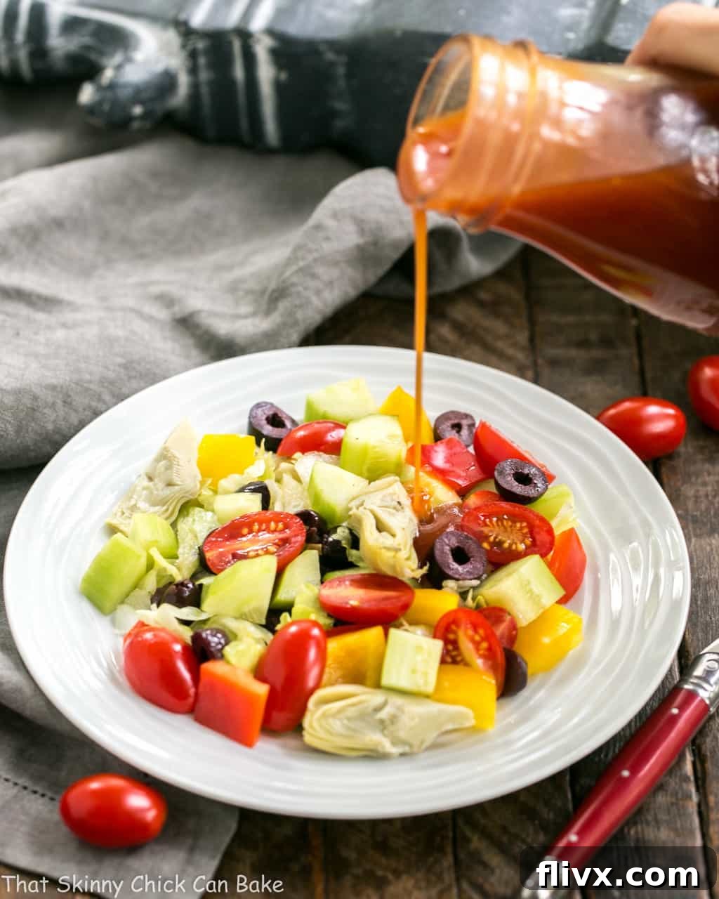 Rich and creamy Honey French Salad Dressing being generously poured over a fresh green salad, highlighting its perfect consistency.
