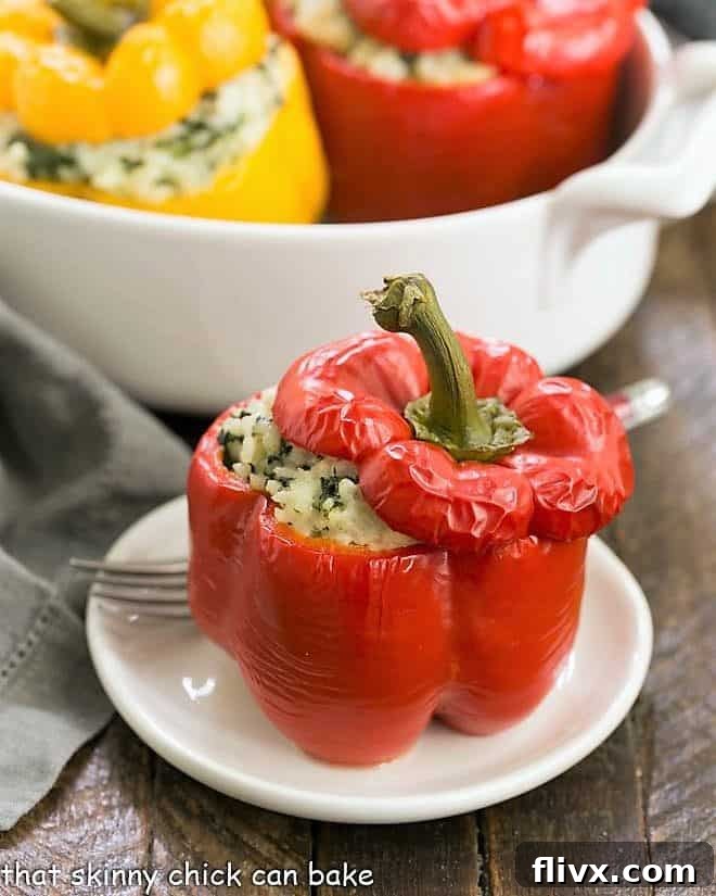 Rice Packed Peppers on a white plate, showcasing the golden-brown cheese and vibrant spinach filling