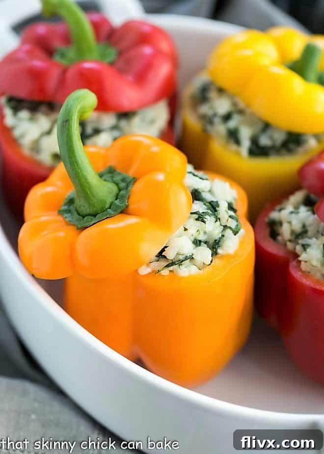 Rice Packed Peppers nestled in a white baking dish, ready for the oven