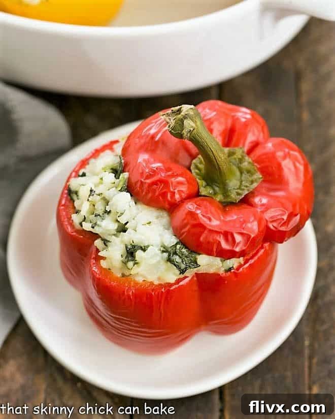 Dorie Greenspan's Rice Packed Peppers on a white ceramic plate, showing the rich, cheesy filling