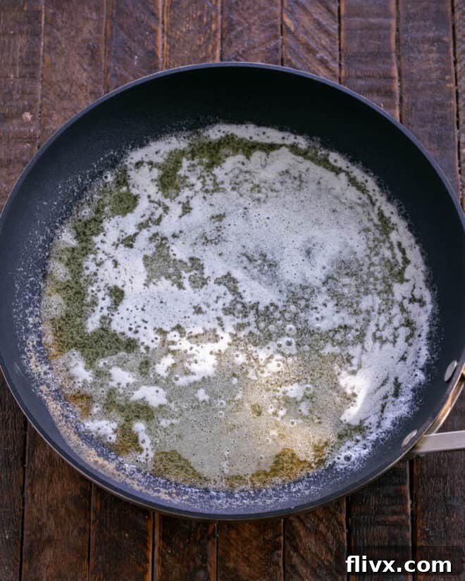 Melted butter in a large skillet, ready for ingredients.
