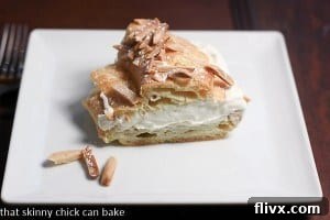 Top-down view of a complete Paris-Brest, showing its distinctive ring shape and almond topping