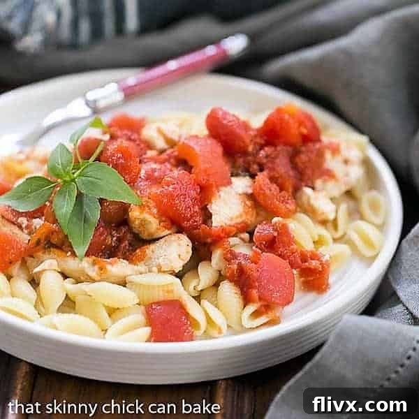 Chicken Feta Casserole in a white bowl garnished with basil