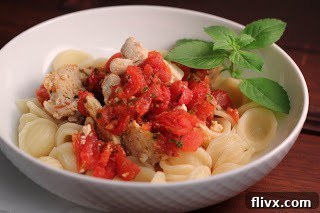 Chicken Feta Casserole in a white bowl with a sprig of basil, ready for a delicious meal.