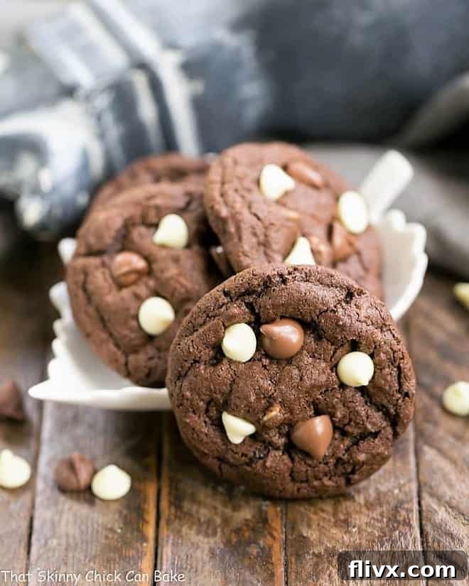 Triple Chocolate Fudge Cookies nestled in a decorative leaf-shaped bowl, with one cookie leaning against it, tempting you to grab it.