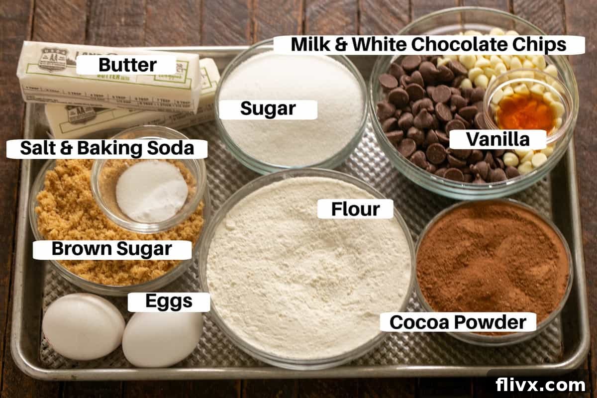 Various baking ingredients for Triple Chocolate Fudge Cookies, neatly arranged on a metal sheet pan.