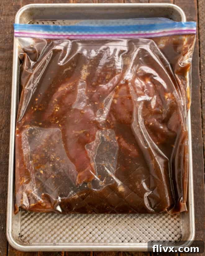 Flank steak marinating in a Ziploc bag in the refrigerator.