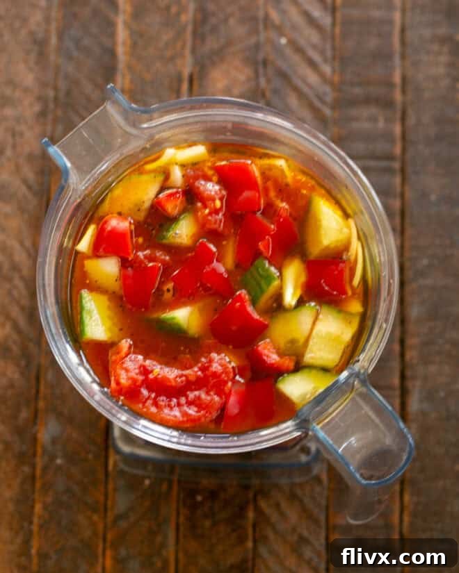 Blender pureeing gazpacho ingredients until smooth.