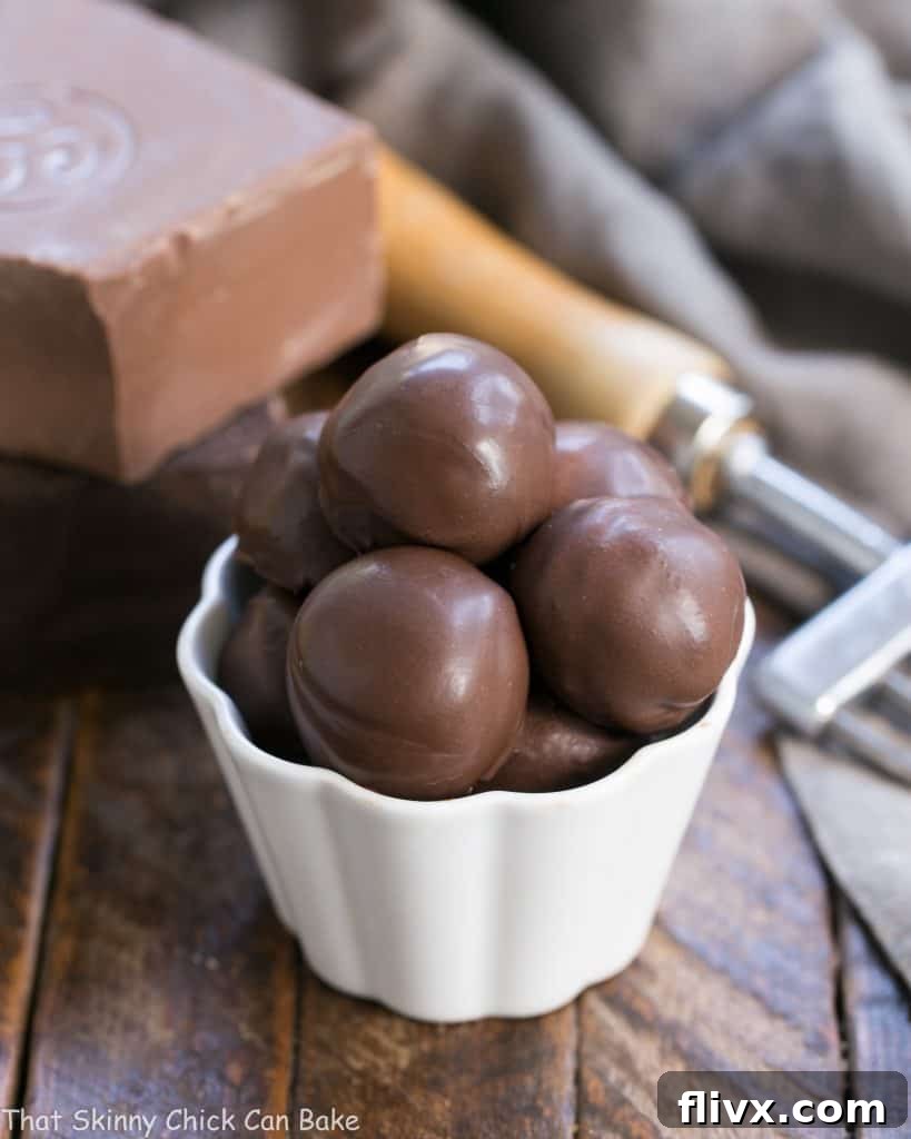 Exquisite Chocolate Frangelico Truffles presented beautifully in a small white candy bowl, highlighting their glossy finish and decadent appeal.