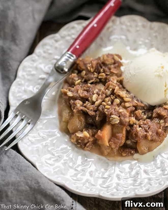 Easy Slow Cooker Apple Crisp on a decorative white plate, ready to be served.