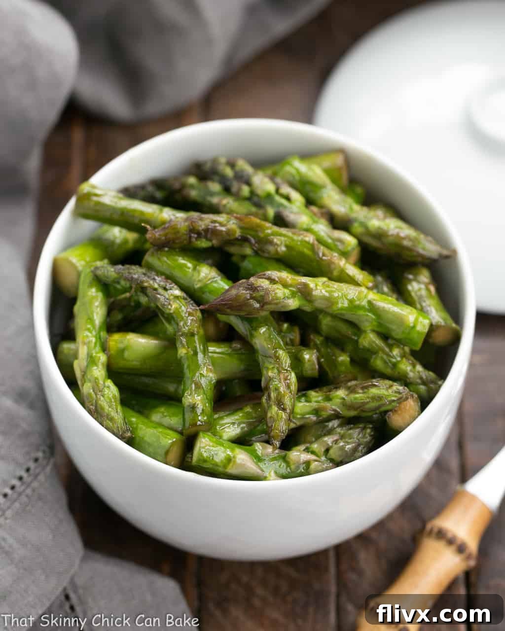A white bowl of Asian Stir Fried asparagus
