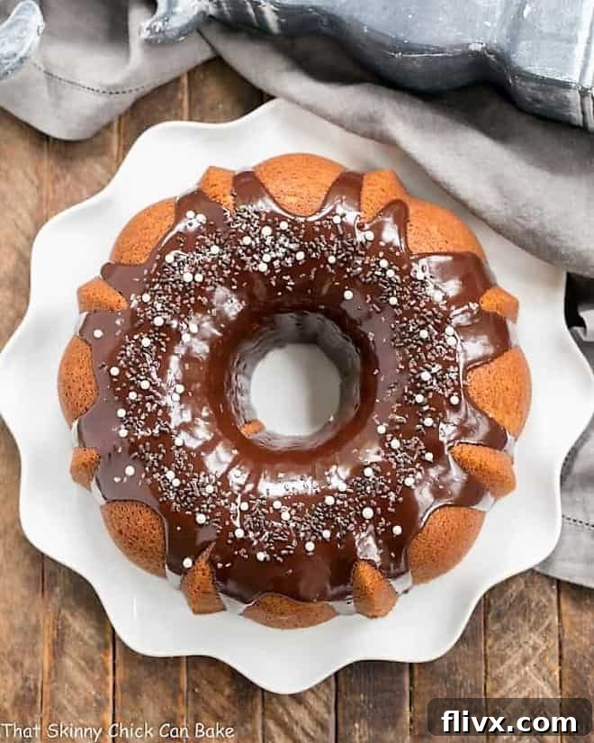 Overhead view of Tunnel of Fudge Cake on a white ripple edge plate, emphasizing the beautiful pattern of the Bundt cake.
