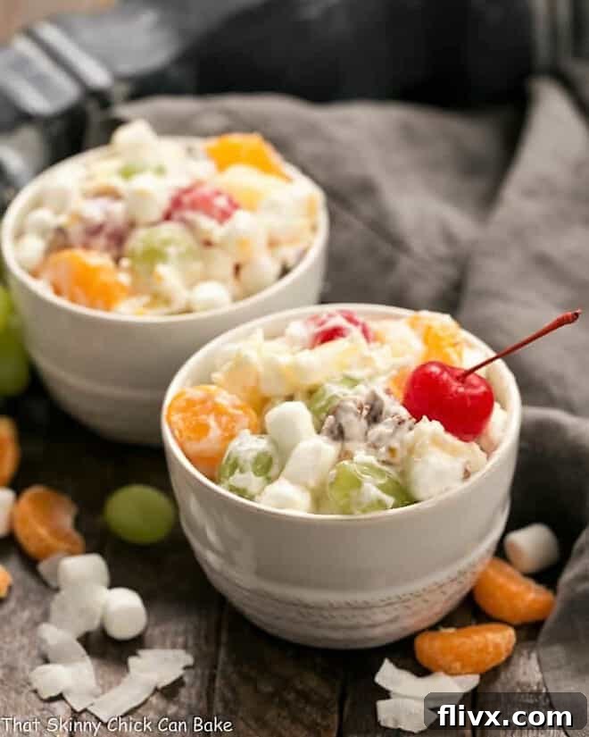 Two small white bowls filled with The Best Ambrosia Salad {No Cool Whip}.