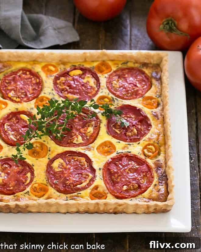Overhead view of Tomato Gruyere Tart on a square white platter