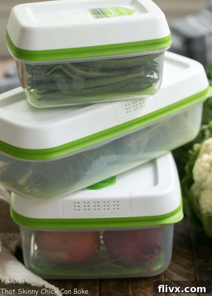 Close-up of the Roasted Fall Vegetable Salad, showcasing the rich textures and colors of roasted butternut squash, beets, farro, and goat cheese on a bed of fresh spinach.
