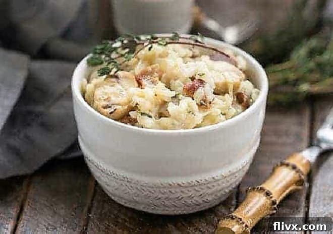 A bowl of creamy bacon mushroom risotto, garnished and ready to serve. The image captures the inviting texture and deliciousness of the dish.