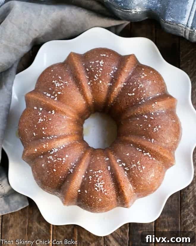 A golden-brown Kentucky butter cake, perfectly baked in a Bundt pan, sitting on a wire rack.
