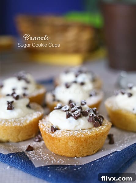 Cannoli Sugar Cookie Cups filled with creamy cannoli cream and mini chocolate chips, arranged beautifully on a platter.