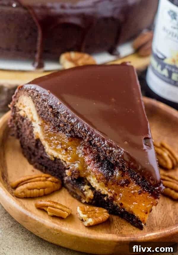 A stunning Chocolate Pecan Piecaken, a rich chocolate cake with a full pecan pie baked inside, sliced to reveal the layers.