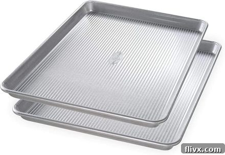 Two sturdy half sheet pans, ideal for baking cookies and roasting vegetables.