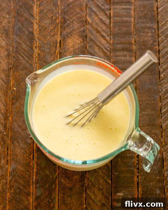 Adding buttermilk to the egg mixture.