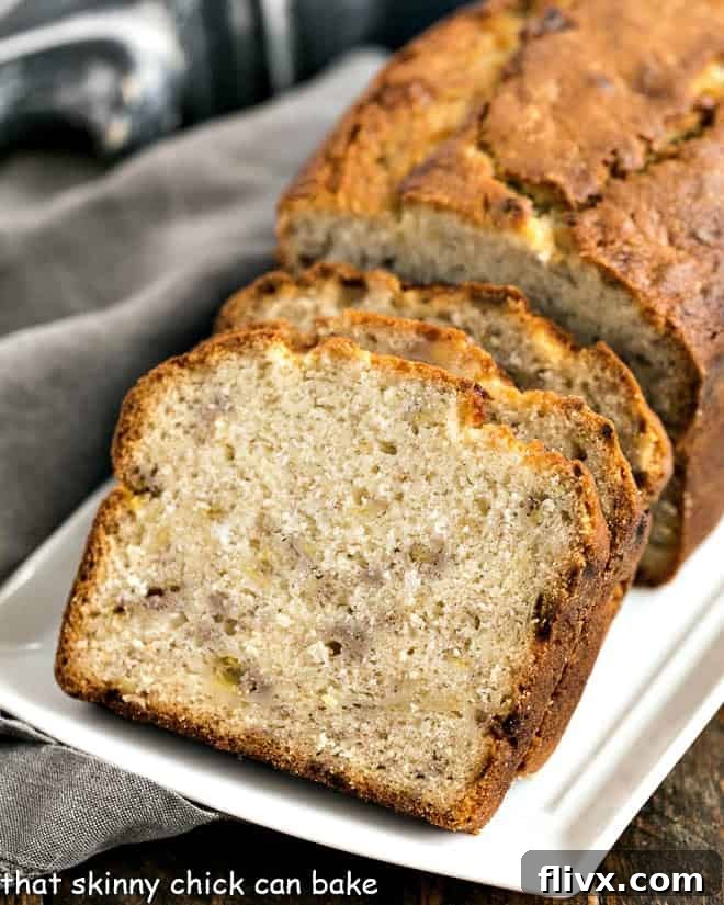 Slices of golden-brown Buttermilk Banana Bread arranged on an elegant white ceramic serving tray, highlighting its tender crumb and inviting texture.