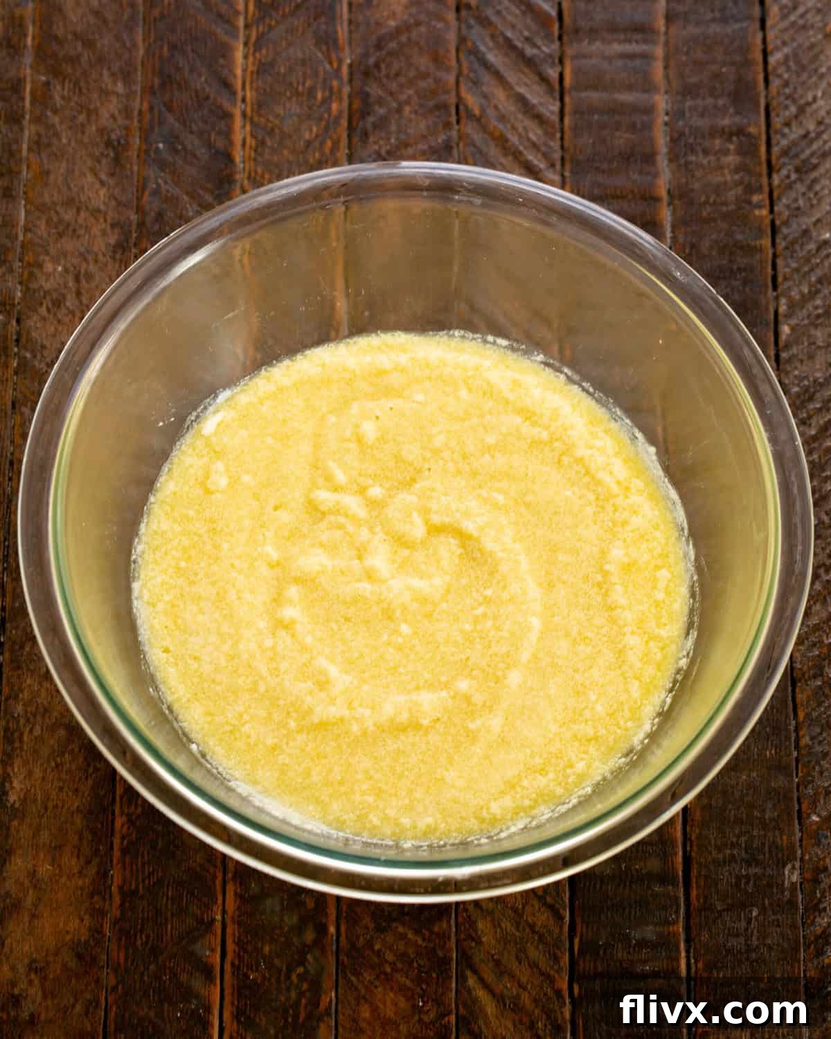 Step 3: Mashed bananas, eggs, vanilla, and buttermilk being added to the creamed butter and sugar mixture.