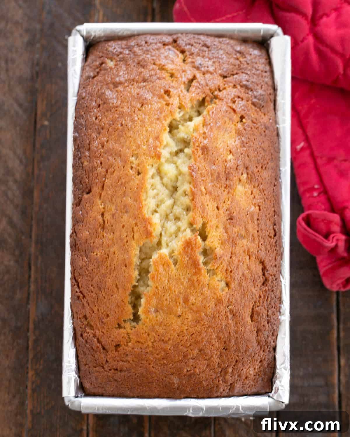 Step 6: Banana bread batter scraped into the prepared loaf pan, ready for baking.