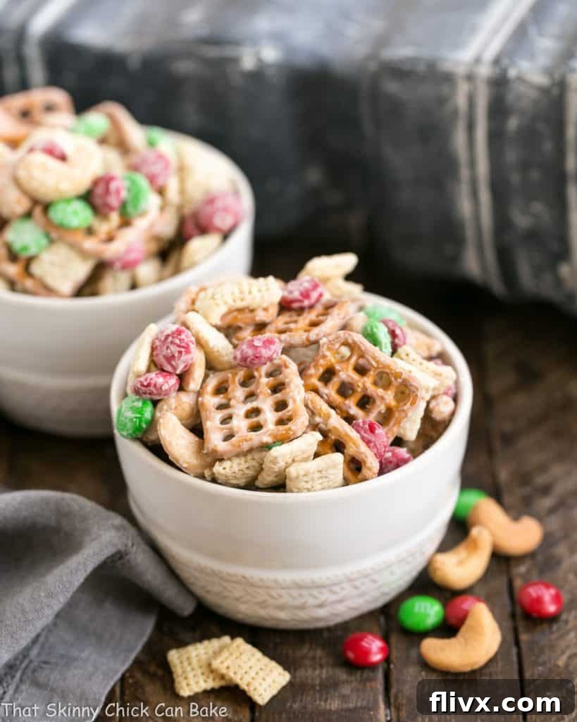 Two aesthetically pleasing small bowls overflowing with delicious holiday snack mix, perfectly portioned for sharing