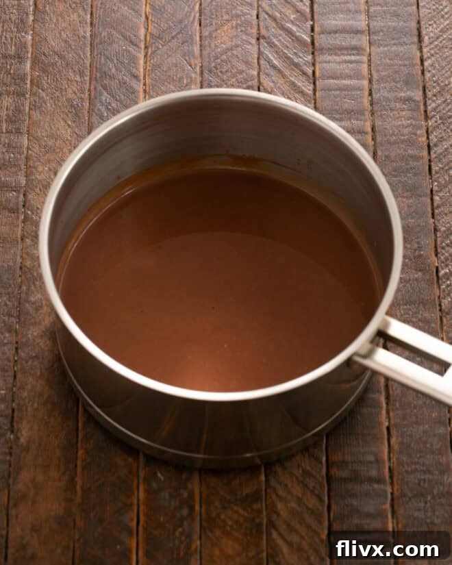 Add chopped semi-sweet chocolate to hot cream and stir until fully melted and smooth.