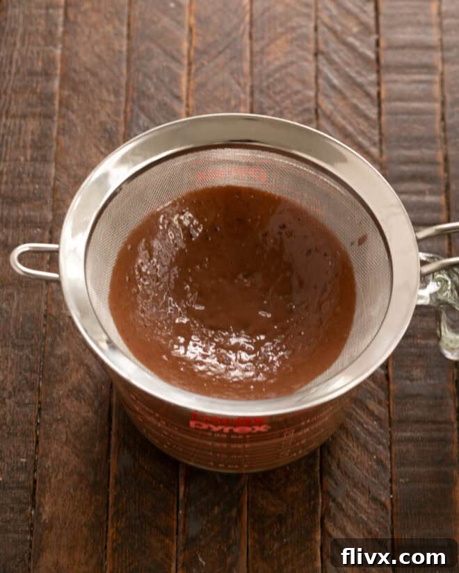 Whisk egg yolks and sugar, then slowly temper with the hot chocolate mixture, straining afterwards.