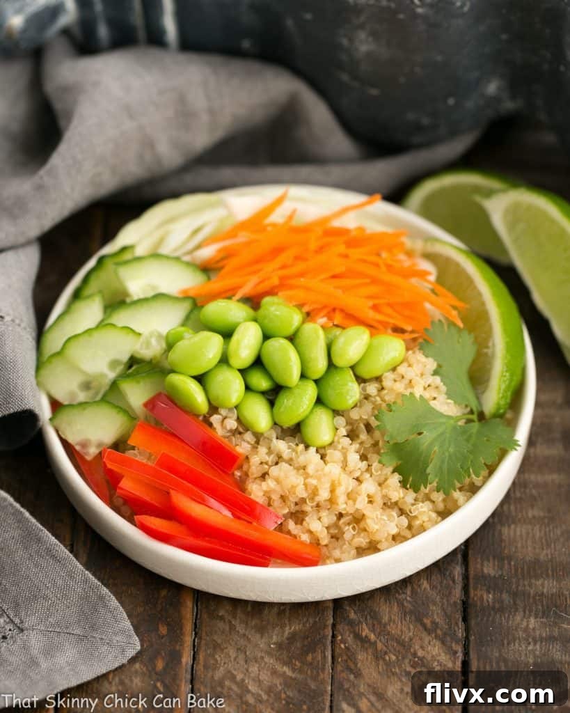 A beautifully arranged Thai Vegetable Quinoa Bowl in a white ceramic bowl, showcasing vibrant vegetables and fluffy quinoa.