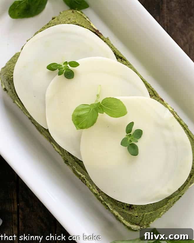 Overhead view of pestoand sundried tomato dip before serving on a white tray