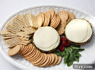 Overhead view of layered Italian dip on a tray with crackers
