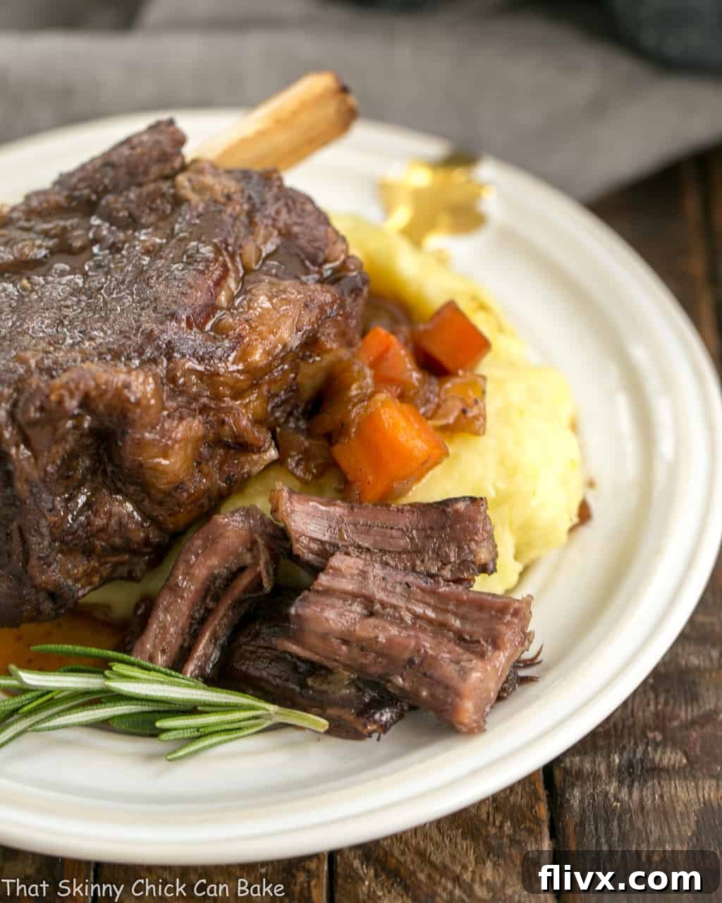 Instant Pot Beef Short Ribs on a white plate with mashed potatoes.