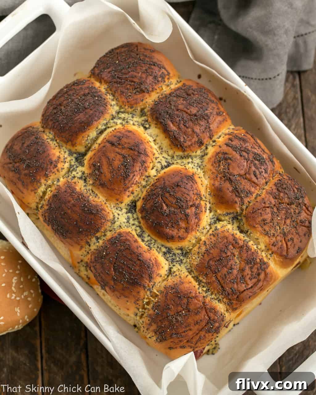Corned Beef Sliders in a white ceramic baking dish viewed from above, showing a full tray of baked sliders.