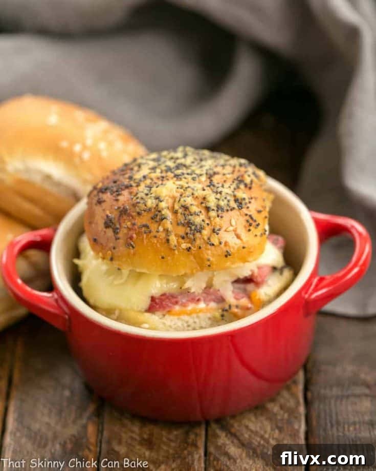 Corned Beef Sliders | All the fabulous flavors of a Reuben Sandwich in a slider! A plate of golden-brown Corned Beef Sliders.