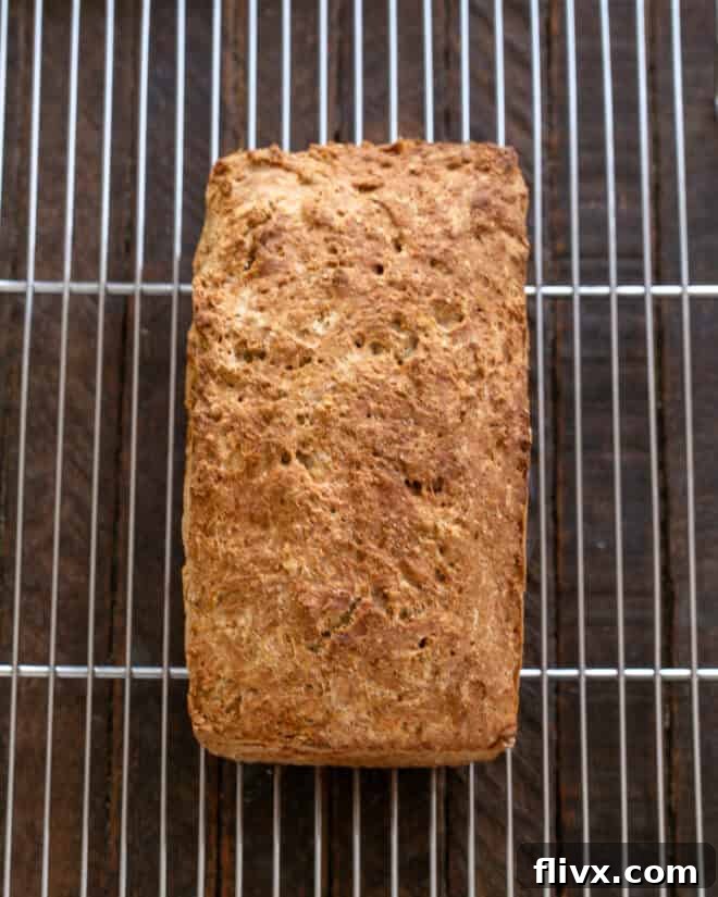 Warm Irish Brown Bread loaf removed from the pan and cooling on a wire rack.