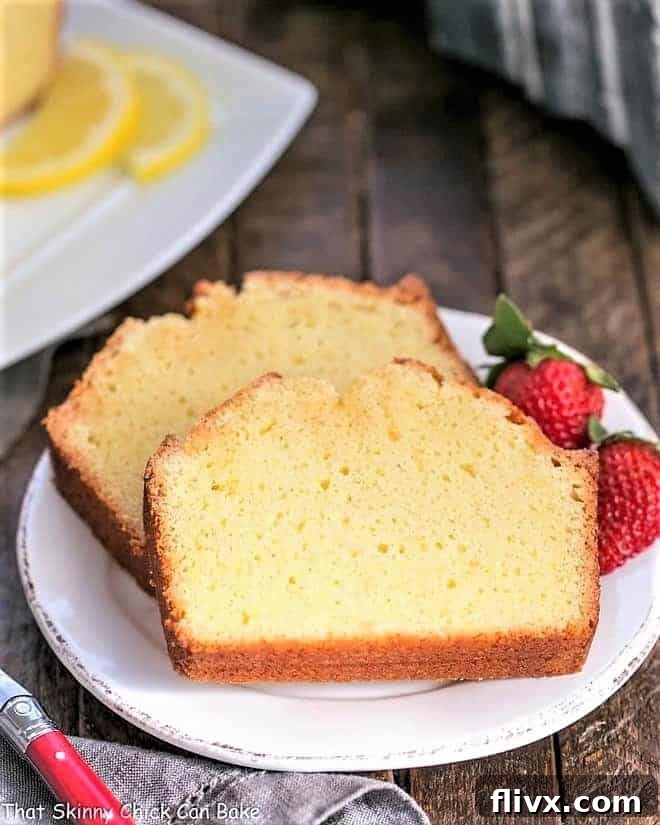 Close-up of Glazed Lemon Pound Cake slices, beautifully arranged and garnished with fresh mixed berries.